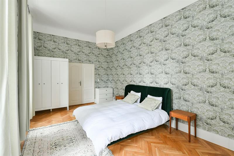 Bedroom wardrobe and chest of drawers beside botanical wallpaper